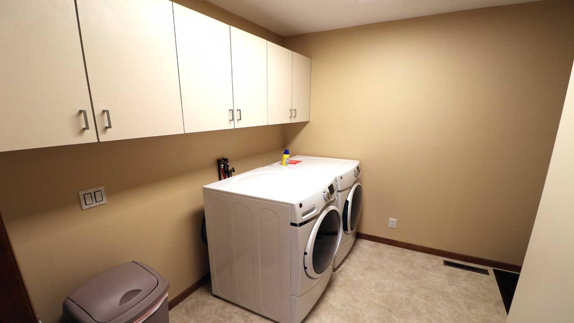Laundry room between two car garage and kitchen