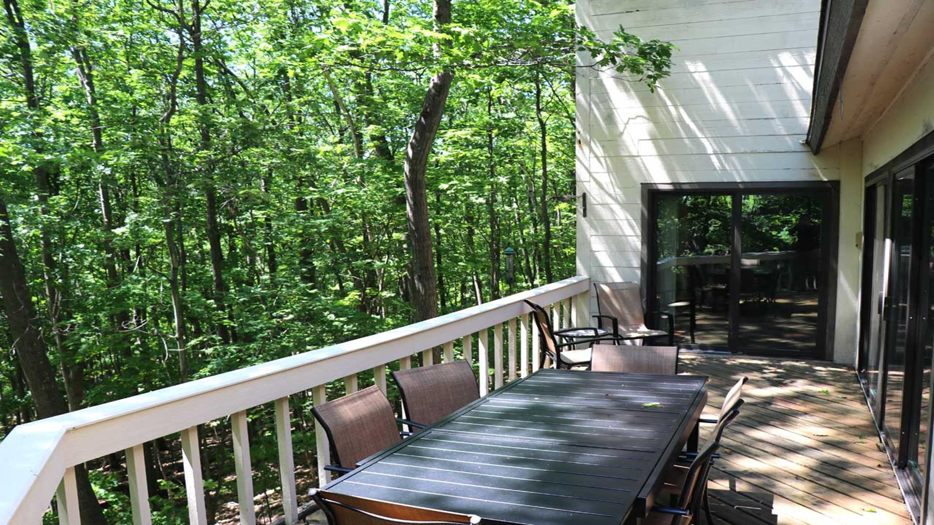 Back deck with patio furniture with seating for 8